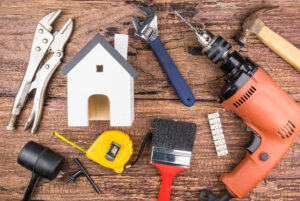 Photograph of various tools and wooden house